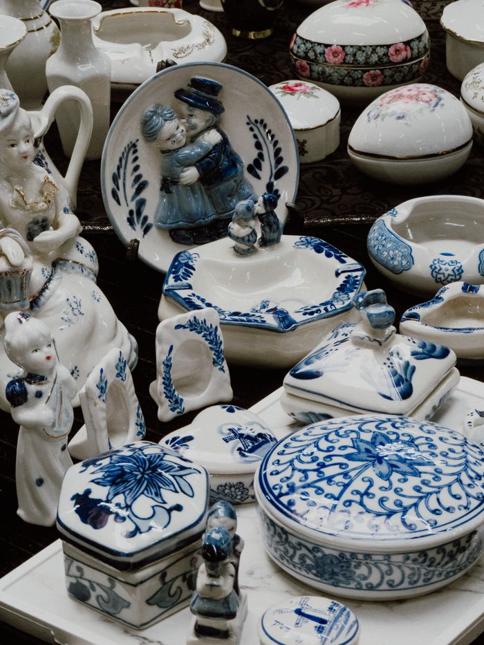 Beautiful display of handmade blue and white ceramic pottery with intricate designs and figures.